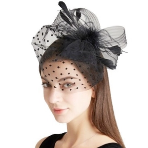 Vintage black fascinator hat with polka dot mesh, elegant feathers, and bridal hair clip