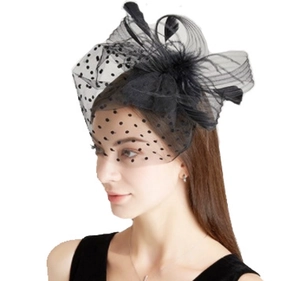 Detail of black bridal fascinator with polka dot mesh veil and elegant feathers