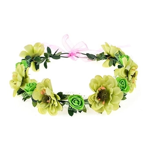 Close-up of green artificial flower crown with realistic leaves and pink ribbon tie