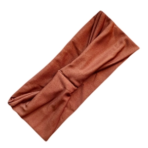 Detailed texture of breathable brown milk silk fabric on an elastic sports headband