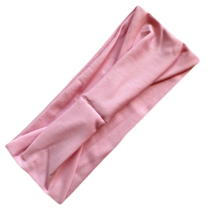Close-up of pink high-elastic milk silk headband with breathable texture on white surface