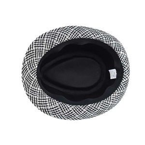 Detail view of woven hat interior with size 58 label and sweatband in black and white