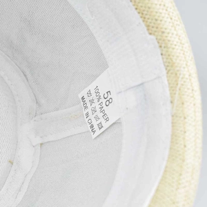 Detail of 100% paper straw hat interior showing size 58 label and quality stitching