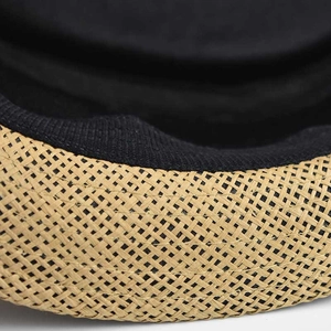Detail shot of the tight linen weave texture and black fabric lining on the fedora hat