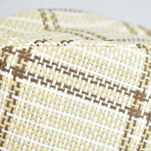 Detailed macro view of woven linen texture and plaid pattern on a men's jazz fedora hat