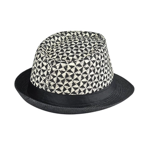 Detail view of a linen fedora featuring black and white geometric woven patterns on the crown