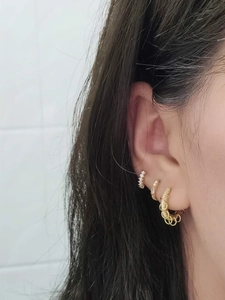 Detail view of S925 sterling silver gold earrings set with micro-paved sparkling crystals