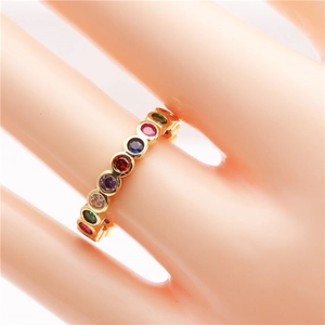 Golden bohemian rainbow ring with colorful zircon stones shown on a model hand