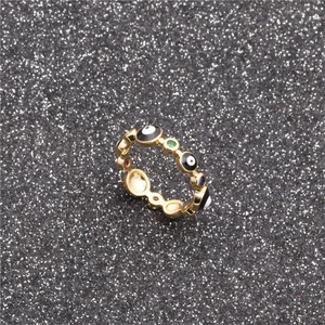 Bohemian gold plated evil eye ring featuring colorful zircons on a sparkling black background
