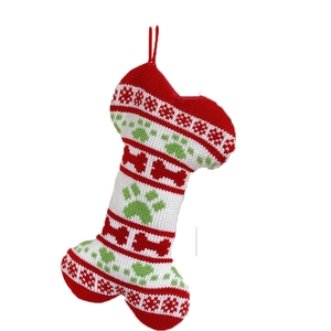 Knitted bone-shaped Christmas pet stocking with snowflake and paw patterns on white backdrop