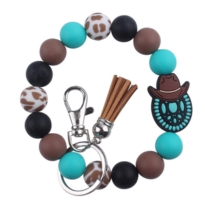 Western style silicone bead wristlet keychain with cow print and leather tassel detail