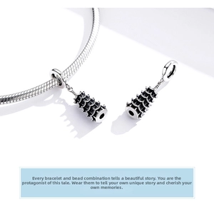 Macro detail of two S925 sterling silver Chinese pagoda pendants on a snake chain