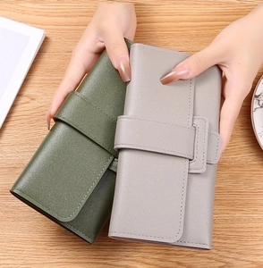 Handheld dark green and light gray leather long wallets with decorative buckle detail