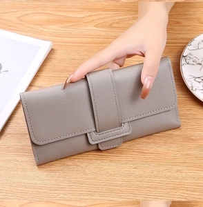 Close-up of grey long wallet with buckle and refined lychee texture stitching details