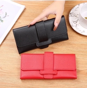 Close-up of trifold long wallets with pebble leather texture in black and red colors