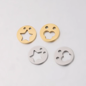 Macro view of mirror-polished square stainless steel pendants in gold and silver finish