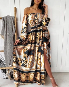 Detailed view of the baroque print and high side slit on this off-shoulder maxi dress