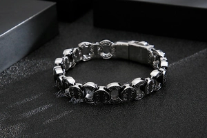 Détail d'un bracelet vintage argenté aux motifs baroques avec un fermoir à charnière