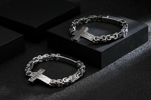 Detail of masculine Byzantine chain bracelet featuring a hammered cross pendant in steel