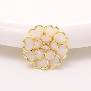 Macro shot of camellia acrylic flower accessory with heart-shaped petals and center zircon
