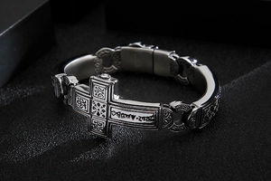 Detailed view of punk style stainless steel bracelet with large cross and vintage carving