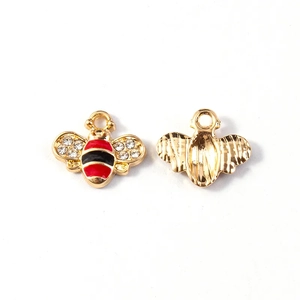 Front and back detail of gold honey bee pendant with enamel stripes and crystals