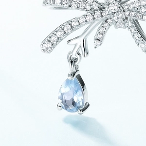 Silver bow necklace with sparkling zircon and light blue pear-cut topaz pendant