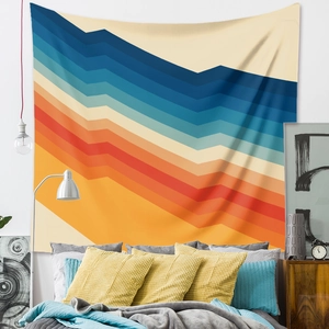 Detail of bohemian tapestry featuring vibrant geometric wave patterns in a cozy bedroom
