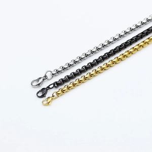 Detail of silver, black and gold box chains with lobster clasps and metallic shine