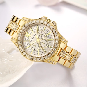 Detailed macro view of luxury gold watch dial with sparkling rhinestones and three-eye design