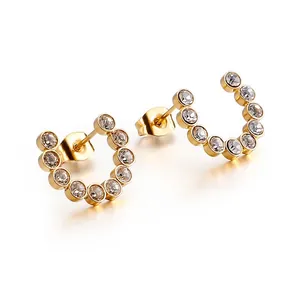 Elegant gold C-shaped hoop earrings with sparkling round crystals on a white background
