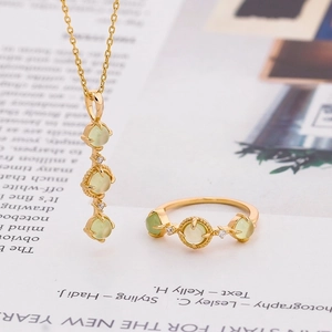 S925 silver necklace and ring set with natural green prehnite stones on a magazine background