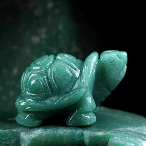 Polished green natural jade turtle statue carving with smooth texture and stone patterns