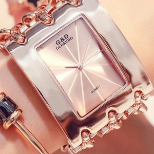 Macro shot of rose gold square quartz watch with textured dial and link strap