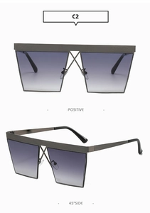 Detail of oversized square sunglasses with metal X-bridge and gradient grey-purple lenses