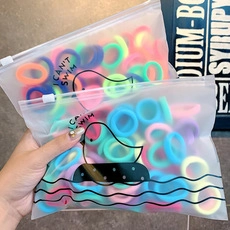 Set of colorful organza scrunchies stored in a frosted zipper bag with a duck pattern
