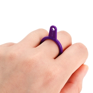 Macro detail of purple plastic ring sizer tool showing size 9 S on finger
