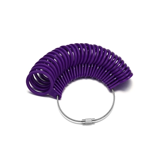 Macro shot of purple plastic ring sizer gauges on a stainless steel wire ring