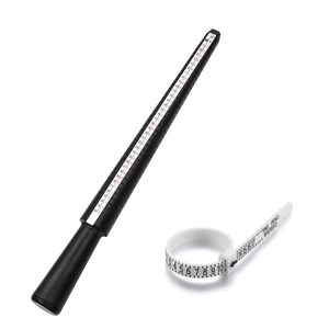 Detail view of black plastic ring sizer mandrel and white measuring tape tool