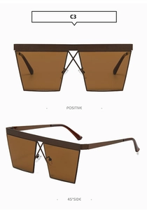 Detail of square oversized sunglasses with brown lenses and double-bridge metal frame