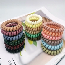 Close-up of colorful spiral telephone wire hair ties in various vibrant pastel colors