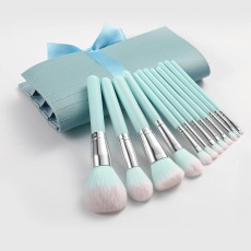 Light blue professional makeup brush set with matching roll pouch and pink tipped bristles
