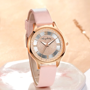 Detail of a pink leather watch with a rose gold crystal-encrusted dial and Roman numerals