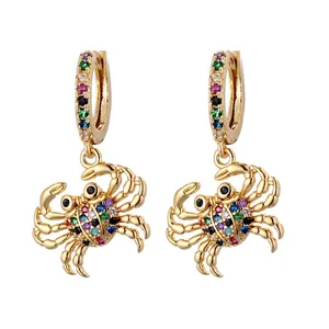 Sparkling gold crab hoop earrings with colorful zircon stones on a white background
