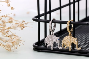 Close-up of elephant earrings with pavé cubic zirconia in gold and silver finish