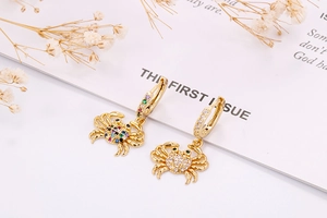 Detail of gold crab earrings with colorful micro-pave zircons and sparkling crystals