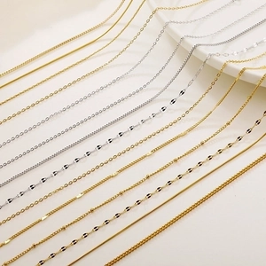 Close-up of various gold and silver chains including snake, box, and cross link styles