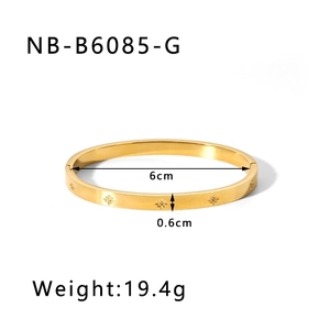 Detail view of gold eight-pointed star engraved bangle with rhinestones and 6cm diameter