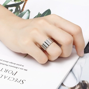 Classic silver titanium steel ring for men with vertical grooved texture on model's finger
