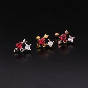 Detailed view of arrow-through-heart earrings in silver, gold, and rose gold finishes